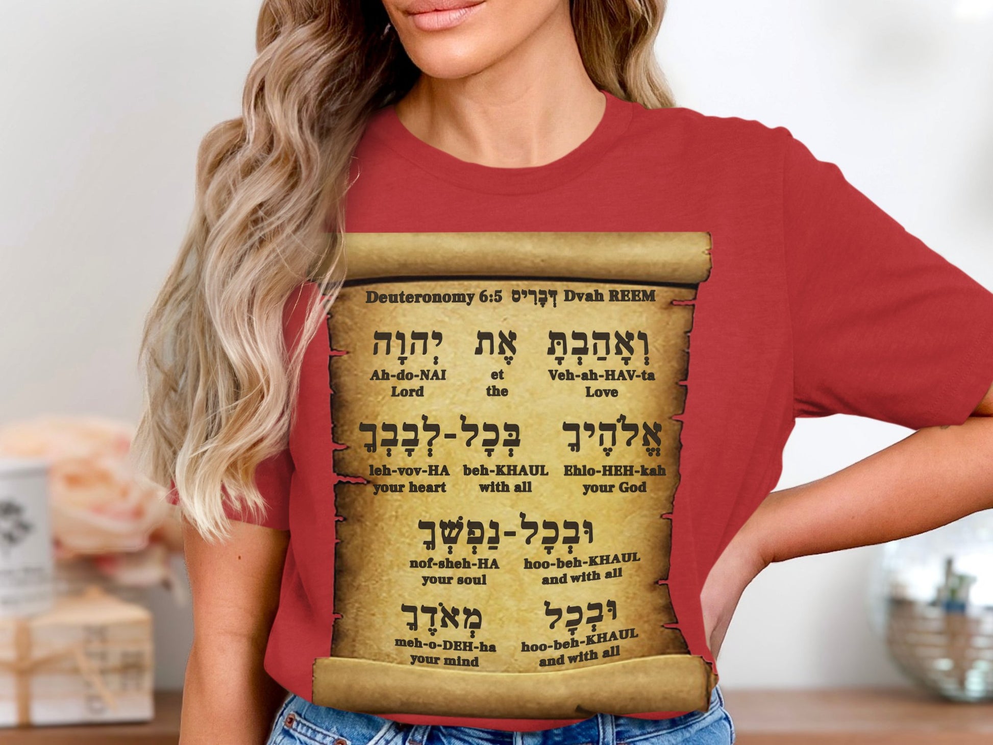 Wear your faith with reverence and style in this soft Bella+Canvas 3001 unisex t-shirt Deuteronomy 6:5 — “Love the Lord your God with all your heart…” beautifully printed in Hebrew, English, and Hebrew pronunciation over a scroll design.