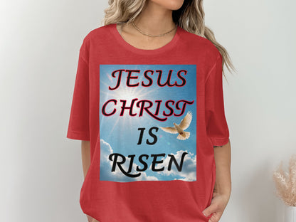 Red t-shirt with 'Jesus Christ is Risen' graphic and dove illustration on a plain background