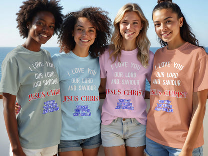 Four women wearing t-shirts with religious text by the ocean.