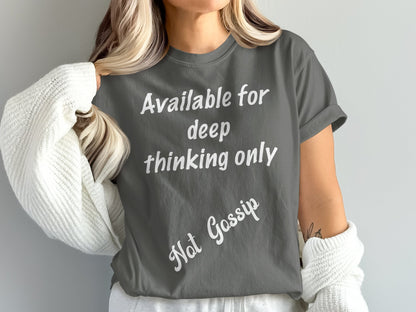 Person wearing a gray t-shirt with text 'Available for deep thinking only, Not Gossip' on a plain background