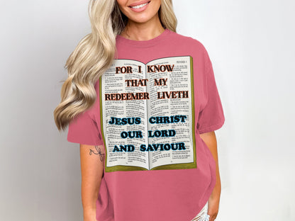 Express your devotion with cozy comfort and a bold declaration. This Comfort Colors 1717 Unisex tee features the scripture-inspired phrase “For I Know My Redeemer Liveth” paired with “Jesus Christ Our Lord and Saviour,” printed over a Bible. The garment-dyed softness and relaxed fit make it ideal for thoughtful reflection and everyday witnessing.