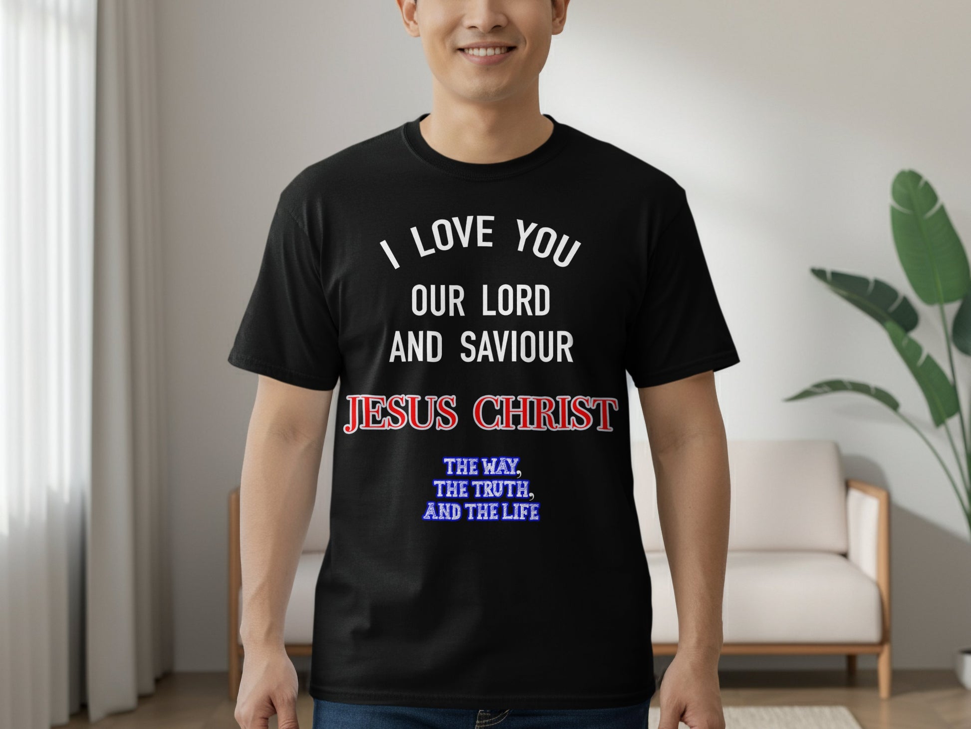 Person wearing a black t-shirt with religious text in a living room.