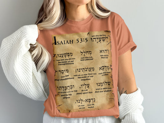 Faith meets comfort and heritage with this Comfort Colors 1717 unisex tee, featuring&nbsp;Isaiah 53:5 in Hebrew and English, along with its pronunciation. The scroll design brings scripture to life in a wearable, soft-washed, vintage-inspired t-shirt – ideal for relaxed wear with powerful meaning of healing.