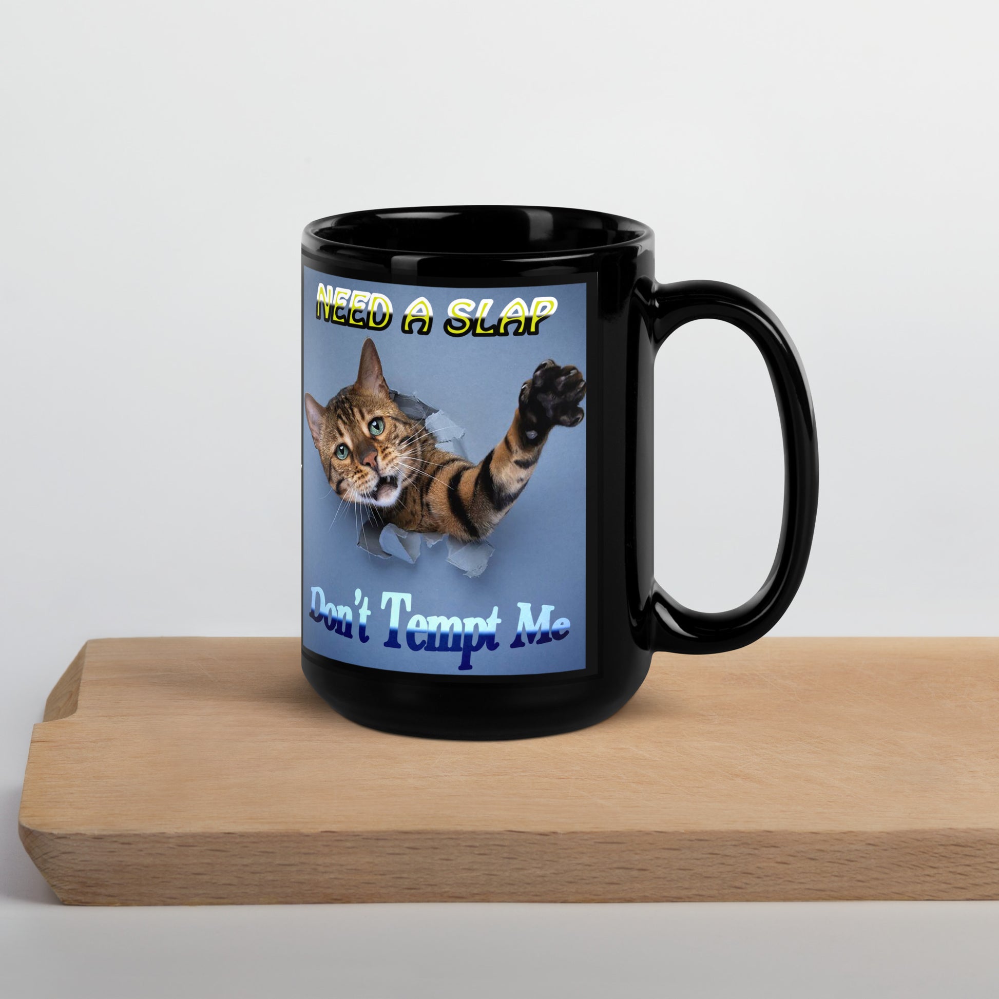 Add a playful dose of sass to your day with this black ceramic personalized mug! Featuring a cat mid-stretch, paw raised, ready to deliver a slap — with the bold phrase:
Need a slap? Don’t tempt me.&nbsp;😼